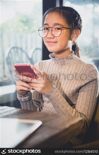 asian teenager holding smart phone in hand smiling face