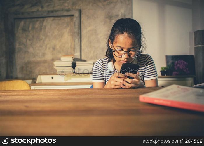 asian teenager reading message in smart phone