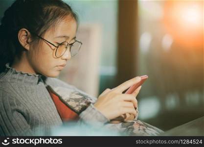 asian teenager reading message on smartphone