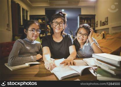 asian teenager student and woman teacher toothy smiling face in modern class room