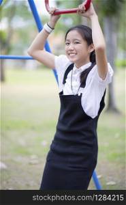 asian teenager toothy smiling face standing in public park