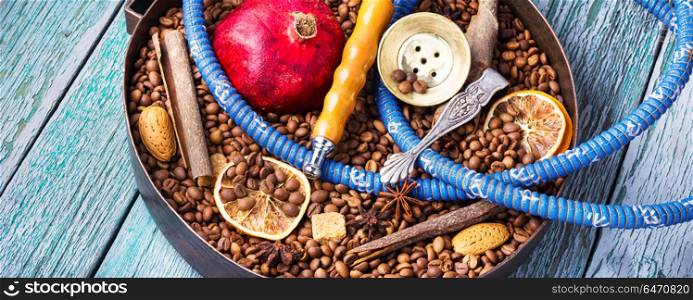 Asian tobacco hookah with coffee aroma. Smoke hookah with with coffee beans and pomegranate.Shisha concept.Hookah concept