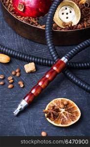 Asian tobacco hookah with coffee aroma. Smoke hookah with with coffee beans and pomegranate.Shisha concept.Hookah concept