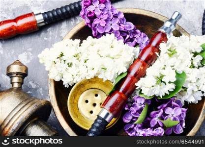 Asian tobacco hookah with floral aroma. Smoke hookah with lilac floral .Shisha concept.Hookah concept