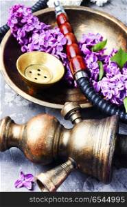 Asian tobacco hookah with floral aroma. Smoke hookah with lilac floral .Shisha concept.Hookah concept
