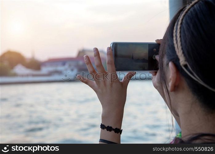 asian tourism take photo with mobile phone to capture moment in destination of Bangkok ,Thailand
