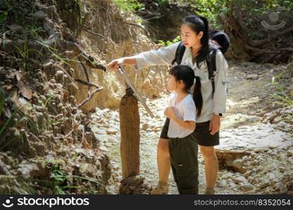 Asian tourist family, mother and daughter travel to the Pha Cho is high soil canyon cliffs at Mae Wang National parks in Chiang Mai,Thailand. Travel and lifestyle concepts