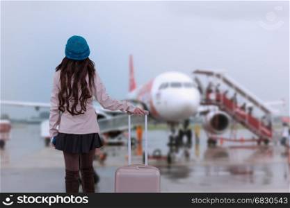 Asian Travel woman wearing sweater coat, blue yarn hat with luggage, waiting at airport for traveler vacation tourist concept