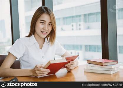 Asian University Teen girl happy smile to learn and education reading a book at library