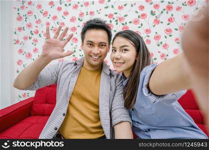 Asian Vlogger of married couple taking video and stream live to attendee via mobile phone by social media channel, say hello and bye bye, lovers and valentine, vlog and influencer freelance concept