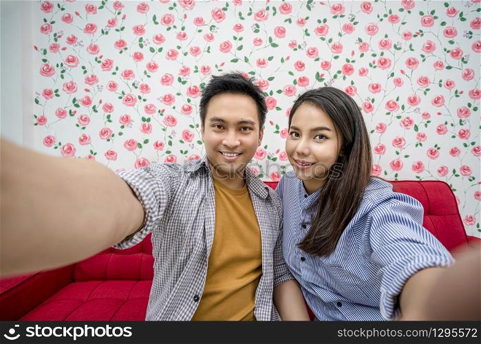 Asian Vlogger of married couple taking video and stream live to attendee via mobile phone by social media channel, say hello and bye bye, lovers and valentine, vlog and influencer freelance concept