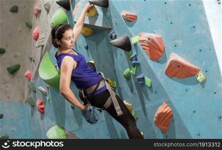 Asian woman climbing rock mountain for adventure and sport. Activity and Health Concept.