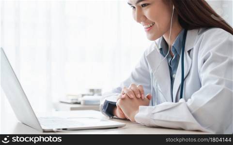 Asian woman doctor is online visiting with a patient on the internet application and Listening of the symptoms and explains how to treat the initial disease, Concept of Medical technology.