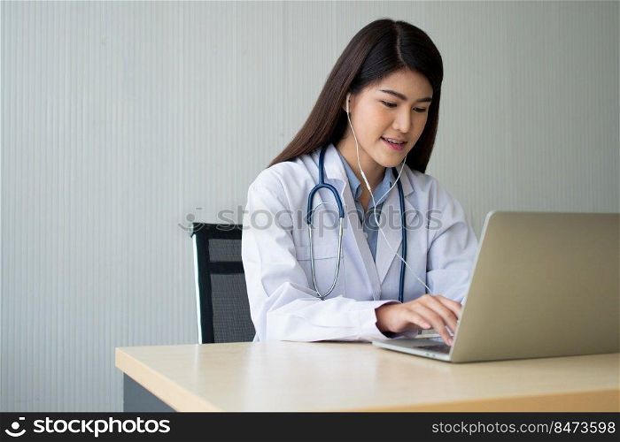 Asian woman doctor is online visiting with a patient on the internet application and Listening of the symptoms and explains how to treat the initial disease, Concept of Medical technology.