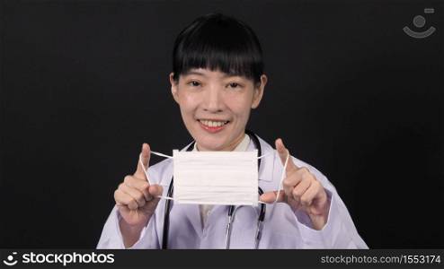 Asian woman doctor wearing or putting medical mask which prevent dangerous coronavirus or covid-19 pandemic virus from Wuhan China and protect bad pollution such as pm 2.5