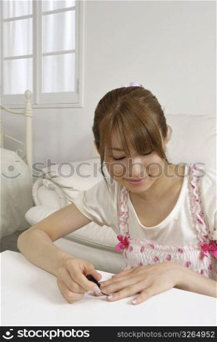 Asian woman doing her nails