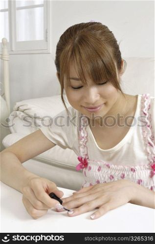 Asian woman doing her nails