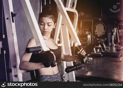 Asian woman doing push ups training arms at gym healthy lifestyle sport concept