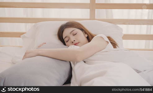 Asian woman dreaming while sleeping on bed in bedroom, Beautiful japanese female using relax time lying on bed at home. Lifestyle women using relax time at home concept.