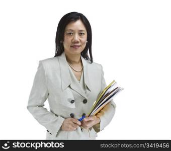 Asian woman dressed in business formal white outfit holding notepads and pen on white background