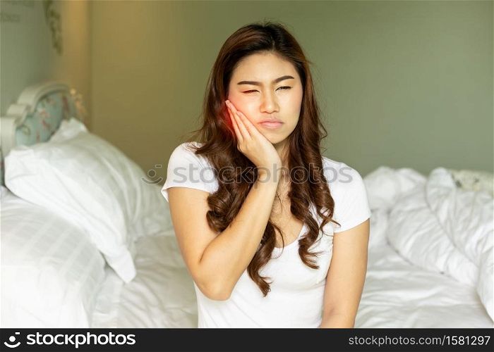 Asian woman have a toothache feeling so painful,Healthcare Concept