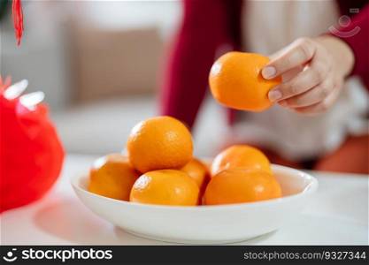 Asian Woman holding mandarin oranges with red gift box thankful present Lunar New Year. Chinese traditional holiday. Lunar new year culture.