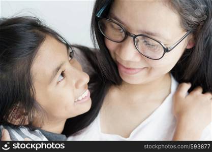 Asian woman hugging cute a girl. Mother and a daughter are smile be happy family.