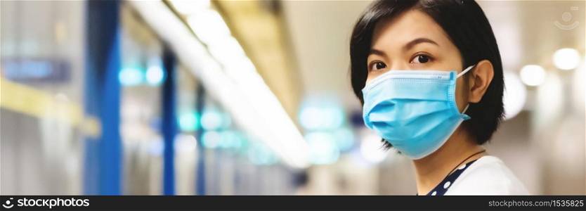 Asian Woman in face mask and waiting commuter train or metro or underground for traveling to work. Young female in public transportation while pandemic virus. Healthcare in New normal life, Web Banner
