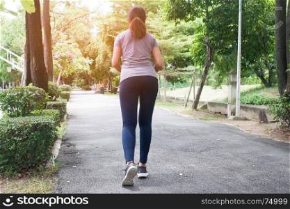 Asian woman in sport clothing jogging in the park, Healthy lifestyle concept