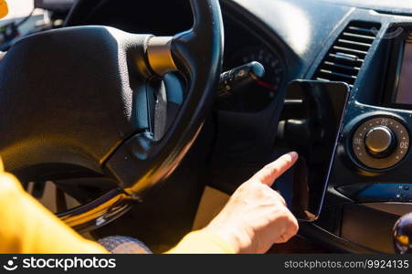 Asian woman inside a car and using touch screen on mobile smartphone blank screen while driving the car in the morning on highway she find navigation location to go Transportation and vehicle concept