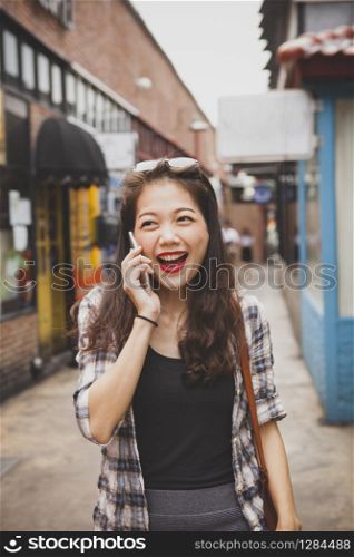 asian woman laughing with happiness emotion in modern shopping area