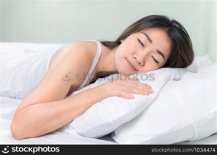 Asian woman lying and sleep on the bed