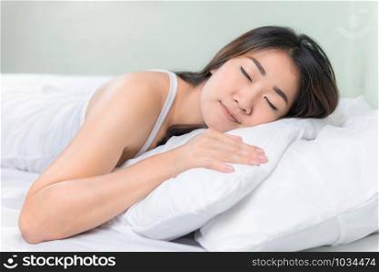 Asian woman lying and sleep on the bed