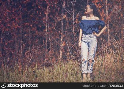 asian woman model pose for fashion photography on dry leaves