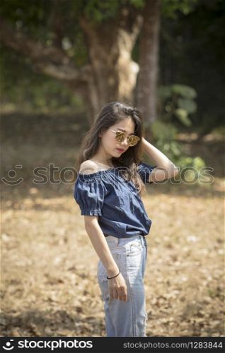asian woman model pose for fashion photography on dry leaves