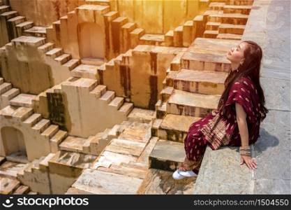 Asian woman posing at Panna Meena Ka Kund stepwell in Jaipur,Rajasthan, India