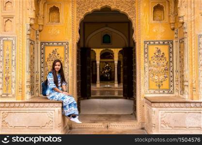 Asian Woman posing in Jaipur from Nahargarh Fort at sunset