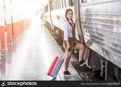 Asian woman pregnant travel carrying her trolley red bag and map at railway station travel,traveler with backpack in summer Holiday concept Thailand