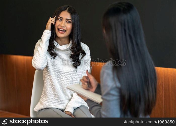 Asian woman professional psychologist doctor giving the consult to female patients in modern living room of house or hospital exam room, Mental health Concept