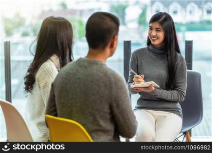 Asian woman professional psychologist doctor giving the consult to lovers patients which have relationship problem in modern living room of house or hospital exam room, Mental health Concept