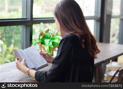 Asian woman reading a book for relaxation time