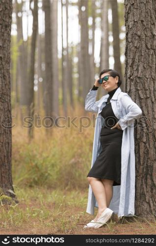 asian woman relaxing emotion toothy smiling in pine forest