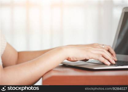 Asian woman’s hand using a computer laptop for the concept of business, communication and media technology.