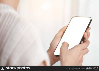 Asian woman’s hand using a smartphone with blank white screen for the concept of business, communication and media technology.