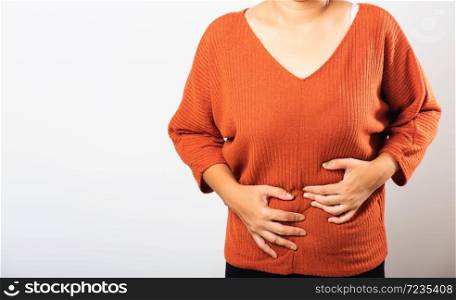 Asian woman she sick have stomach ache holds hands on abdomen, part of body, female having painful stomachache she abdomen bloating or chronic gastritis, studio shot isolated on white background