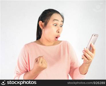Asian woman shocked what she see in the smartphone and made a gesture of success, Isolated on white background.