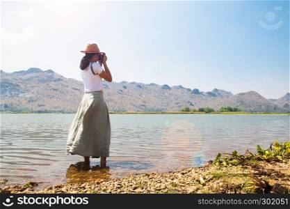 Asian woman shooting photo. Happy traveler. Freedom and lifestyle concept