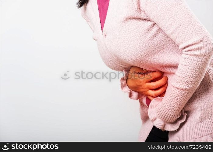 Asian woman sick have stomach ache holds hands on abdomen, part of body, female having painful stomachache she problem disease is constipation or colon, studio shot isolated on white background