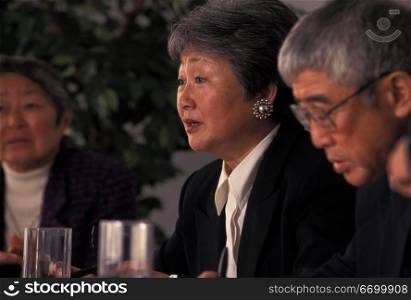 Asian Woman Speaking At Business Meeting