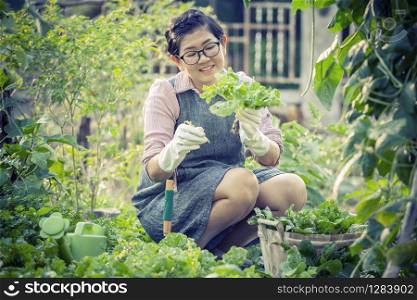 asian woman toothy smiling face in home gardening working
